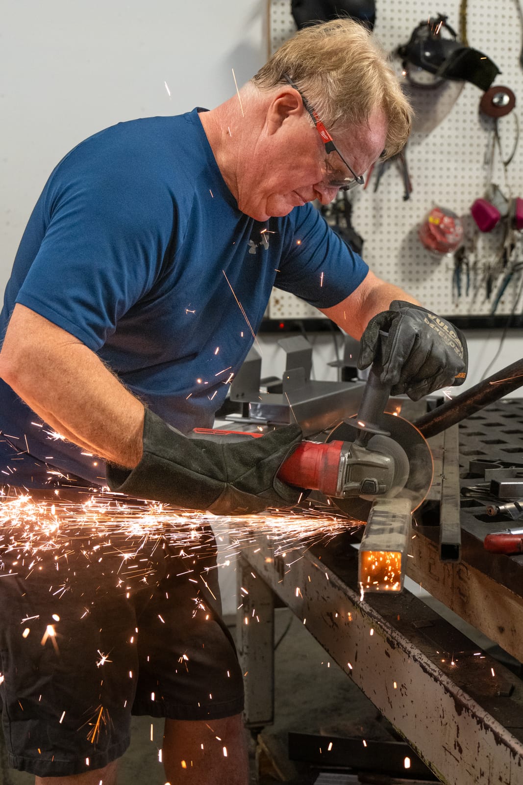 Founder grinding steel in the workshop