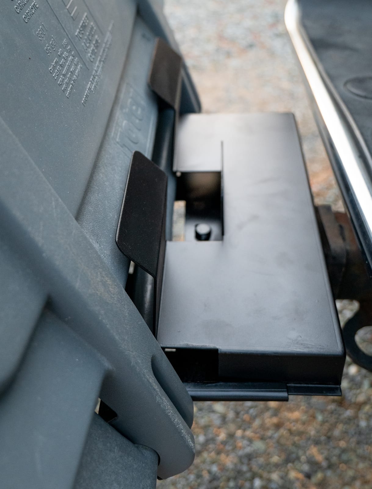 Trash can resting in the cradle, ready to haul